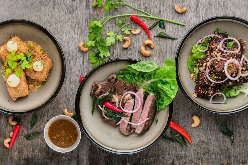 Healthy lunch dishes with fresh salad and grilled meat